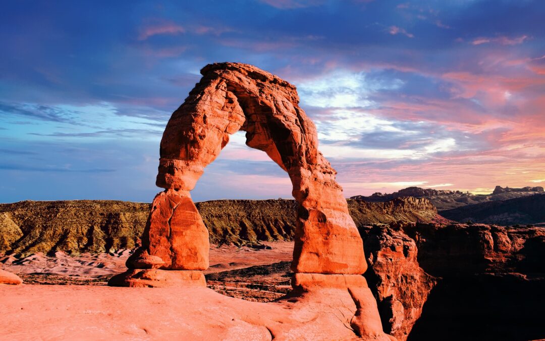 Wind-carved arches scattered on the weathered landscape in Arches National Park is one of the attractions on the Grand Canyon & More tour by Elite-Goody Tours